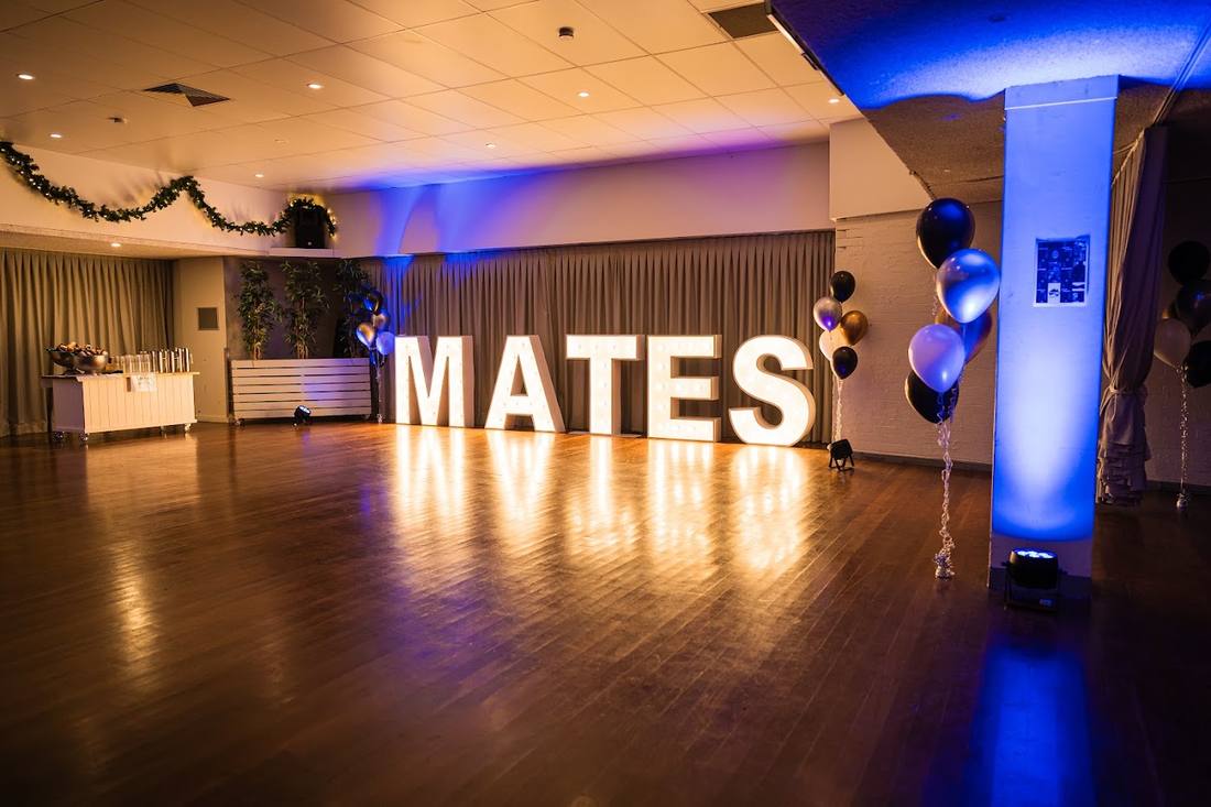MATES marquee letters on the dance floor at the 2024 Mates Ball